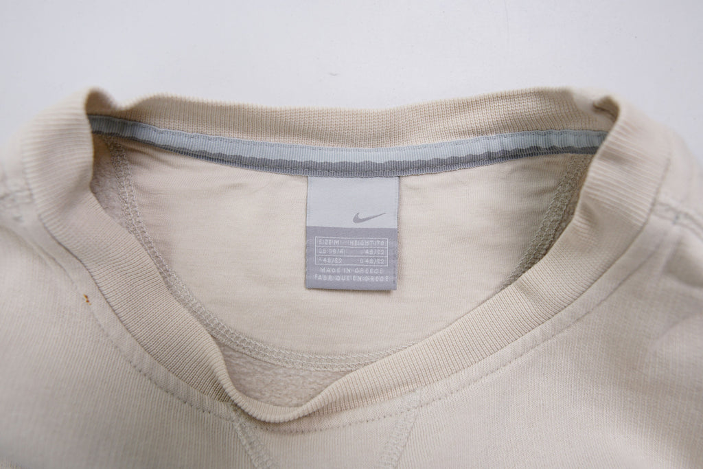 Nike crewneck sweater in beige featuring a small black embroidered Swoosh logo on the chest, size label