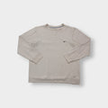 Nike crewneck sweater in beige featuring a small black embroidered Swoosh logo on the chest