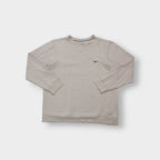 Nike crewneck sweater in beige featuring a small black embroidered Swoosh logo on the chest