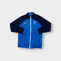 Nike track jacket in blue and navy featuring the Suomi crest on the chest