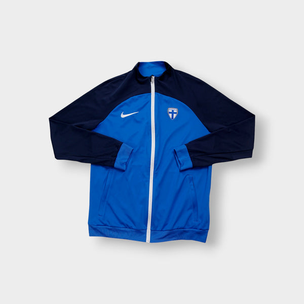 Nike track jacket in blue and navy featuring the Suomi crest on the chest