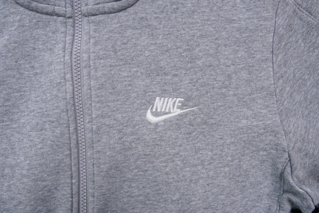 Grey Nike full-zip jacket featuring an embroidered white logo on the chest, detail