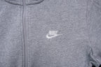 Grey Nike full-zip jacket featuring an embroidered white logo on the chest, detail