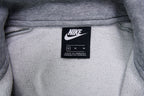 Grey Nike full-zip jacket featuring an embroidered white logo on the chest, size label