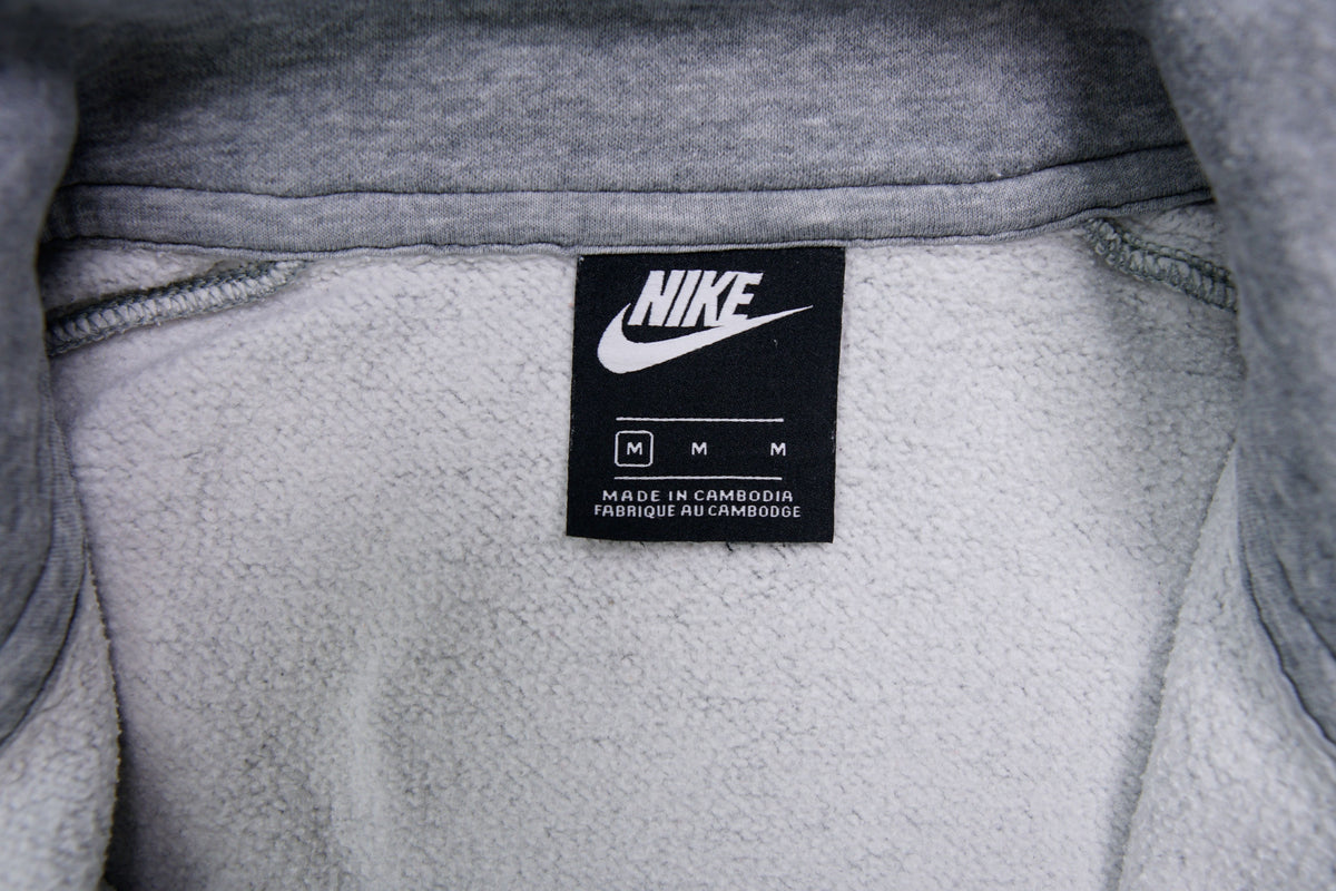Grey Nike full-zip jacket featuring an embroidered white logo on the chest, size label