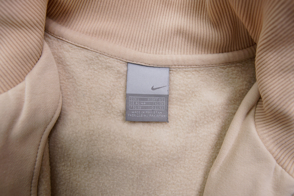 Nike zip jacket in beige featuring a small navy embroidered swoosh on the chest, size label