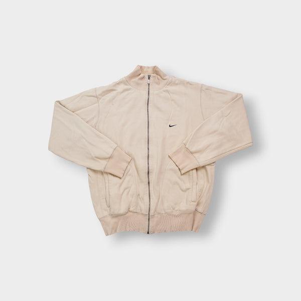 Nike zip jacket in beige featuring a small navy embroidered swoosh on the chest