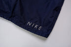 Nike navy jacket featuring a white chest stripe, hooded half-zip, and small embroidered swoosh, detail 4