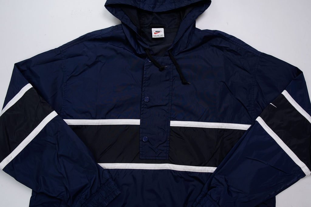 Nike jacket in dark blue and black with hood and white contrast stripes across the chest, full view