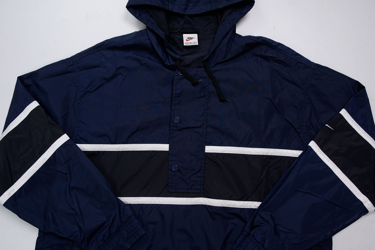 Nike jacket in dark blue and black with hood and white contrast stripes across the chest, full view
