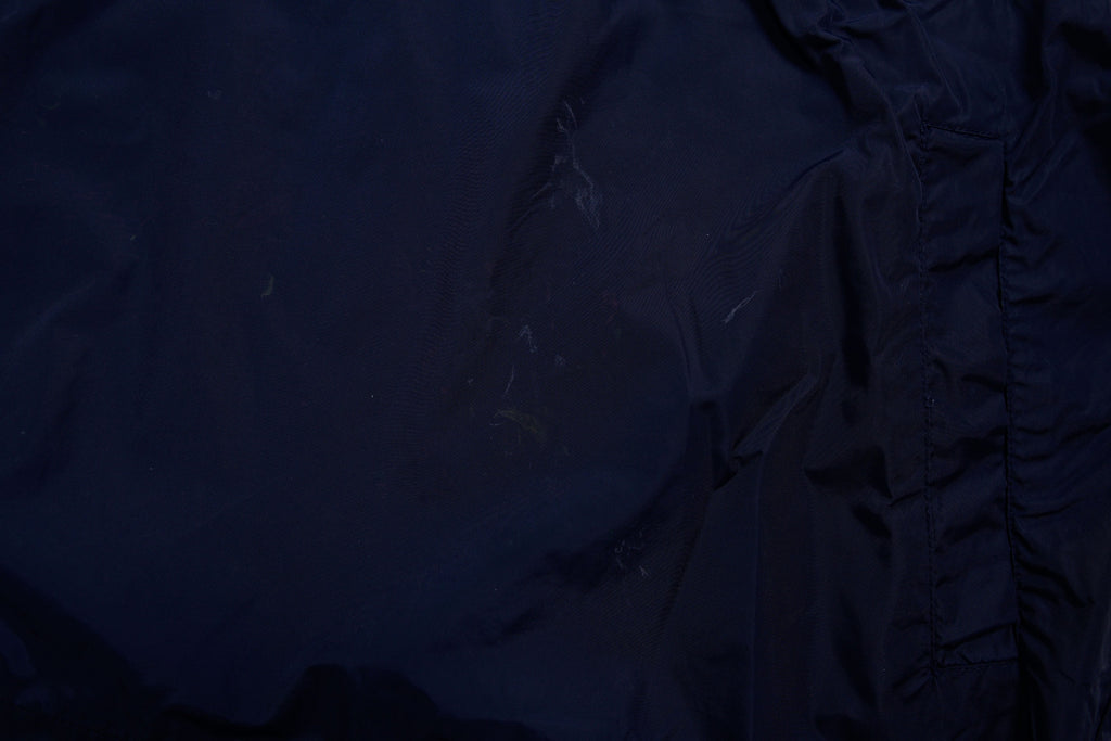 Nike jacket in dark blue and black with hood and white contrast stripes across the chest, detail