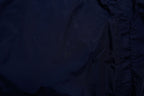 Nike jacket in dark blue and black with hood and white contrast stripes across the chest, detail