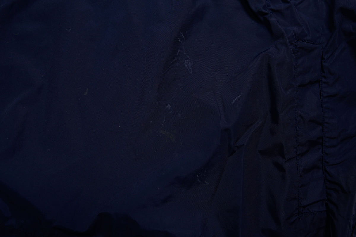 Nike jacket in dark blue and black with hood and white contrast stripes across the chest, detail