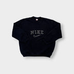 Black Nike sweater with embroidered white spellout logo and Swoosh on chest