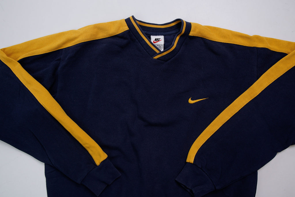 Nike navy and yellow V-neck sweater with yellow sleeve stripes and embroidered swoosh, full view