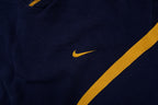 Nike navy and yellow V-neck sweater with yellow sleeve stripes and embroidered swoosh, detail