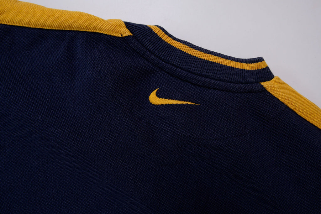 Nike navy and yellow V-neck sweater with yellow sleeve stripes and embroidered swoosh, detail 2