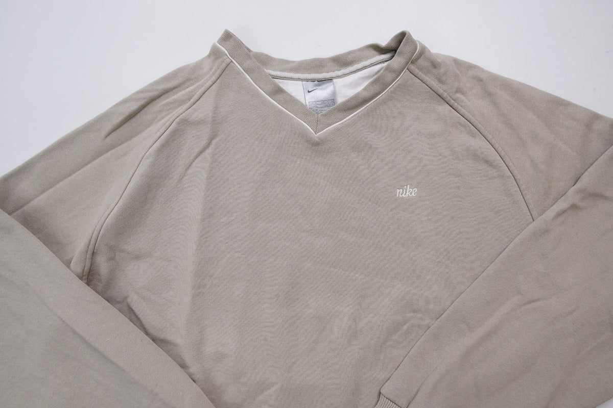 Nike sweater in beige with V-neck detailing and small script embroidery, full view