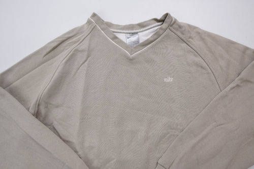 Nike sweater in beige with V-neck detailing and small script embroidery, full view