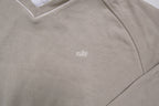 Nike sweater in beige with V-neck detailing and small script embroidery, detail