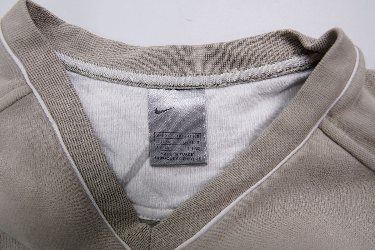 Nike sweater in beige with V-neck detailing and small script embroidery, size label