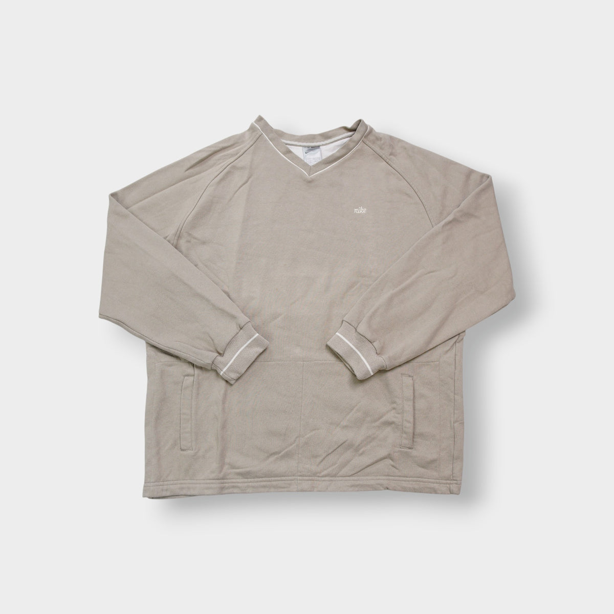 Nike sweater in beige with V-neck detailing and small script embroidery