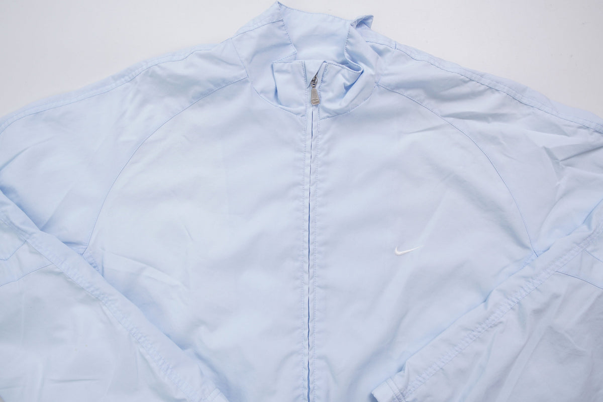 Nike light baby blue zip jacket with small white embroidered swoosh on the chest, full view