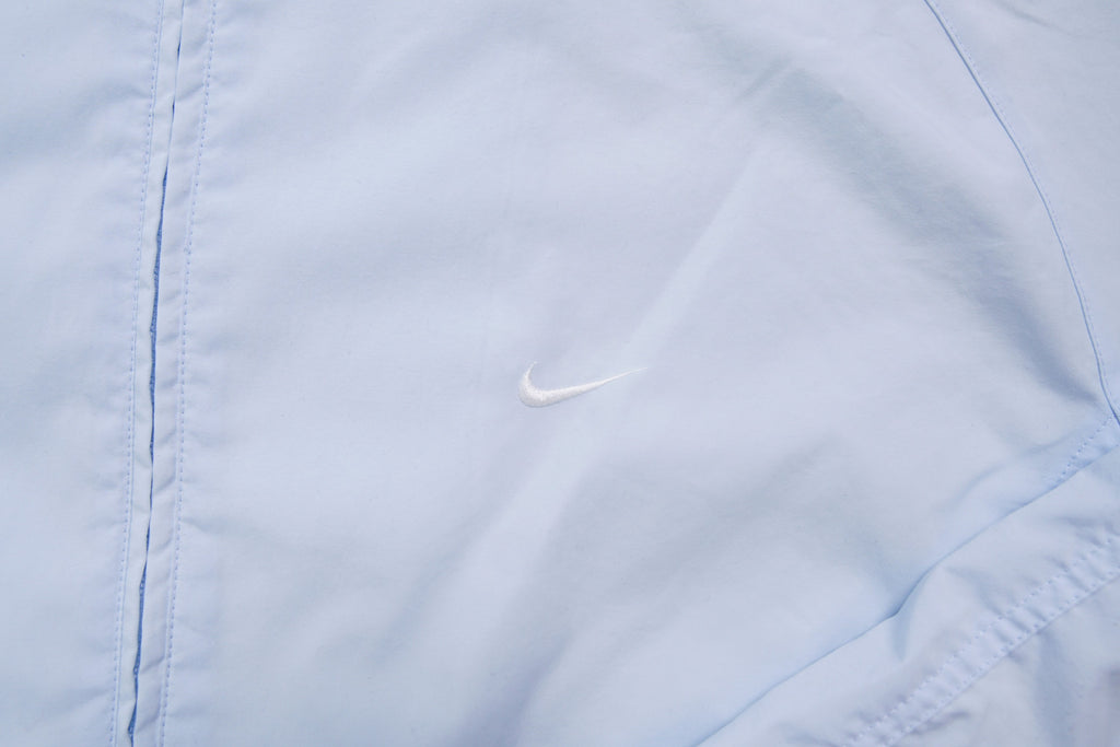 Nike light baby blue zip jacket with small white embroidered swoosh on the chest, detail