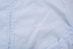 Nike light baby blue zip jacket with small white embroidered swoosh on the chest, detail
