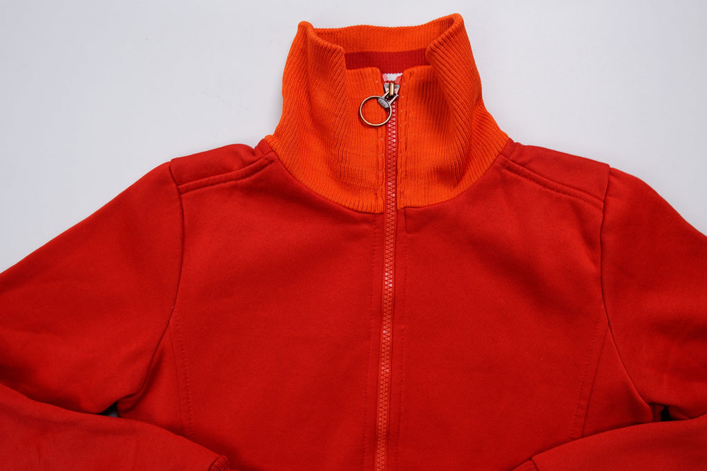 Nike track jacket in red and orange featuring a ring zipper pull and ribbed collar, detail
