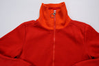 Nike track jacket in red and orange featuring a ring zipper pull and ribbed collar, detail
