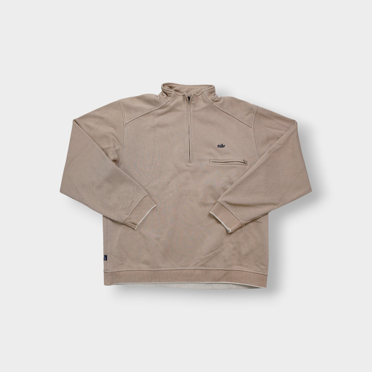 Nike half-zip sweater in beige with small embroidered script logo on the chest