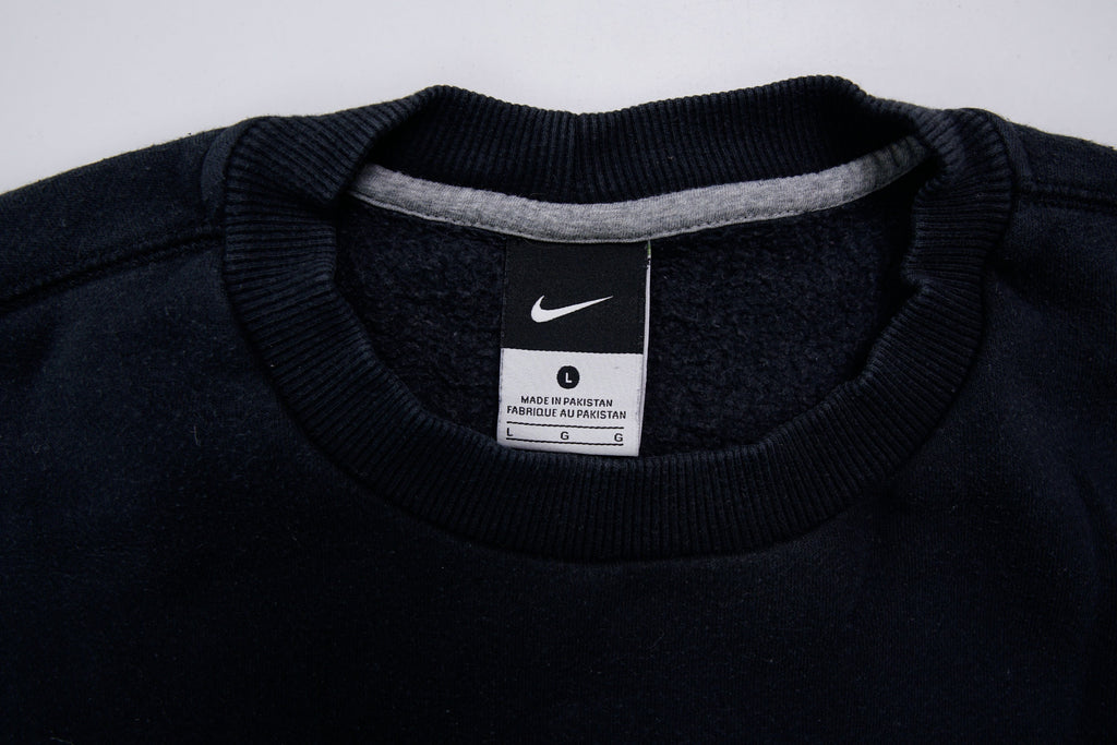 Nike sweater in black with small white embroidered swoosh on left chest, size label
