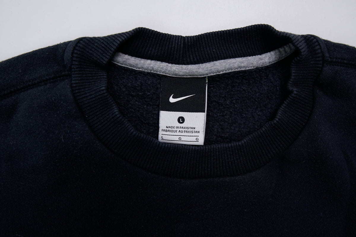 Nike sweater in black with small white embroidered swoosh on left chest, size label
