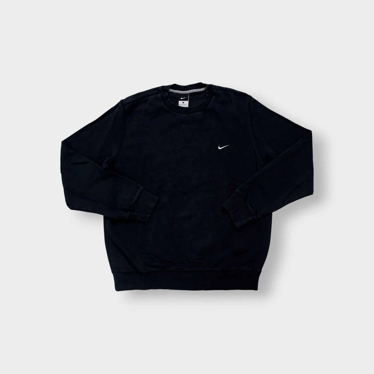 Nike sweater in black with small white embroidered swoosh on left chest