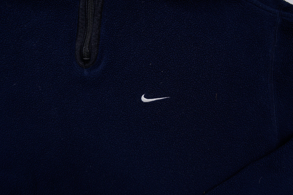 Nike fleece sweater in navy with a half-zip collar and white embroidered Swoosh, detail