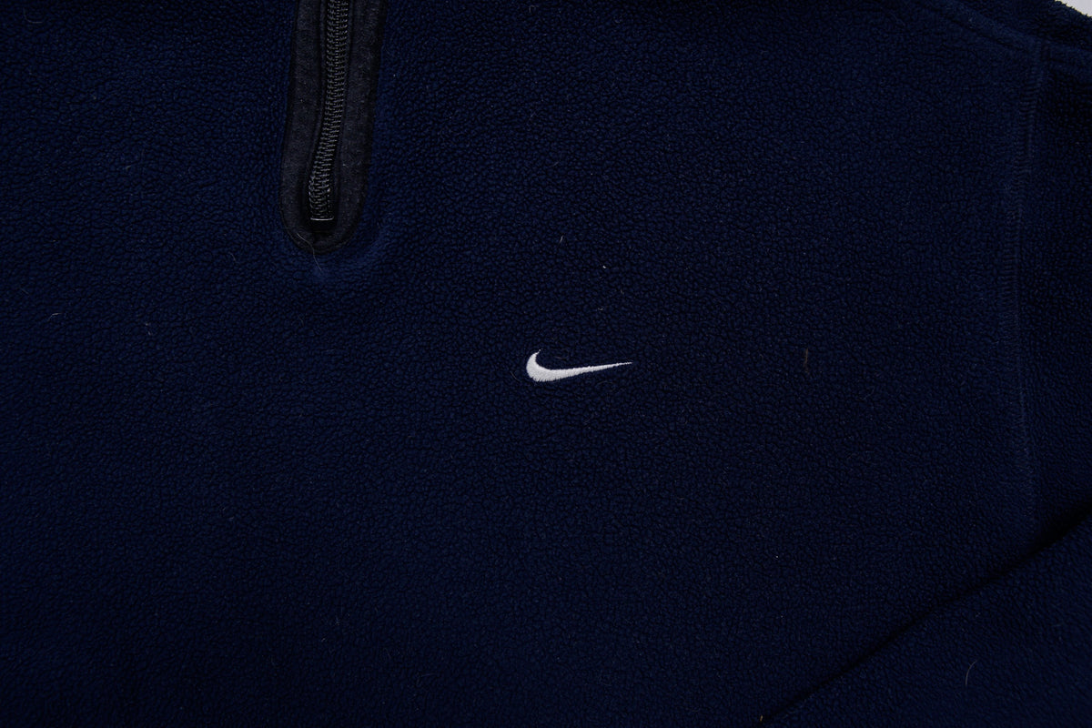 Nike fleece sweater in navy with a half-zip collar and white embroidered Swoosh, detail