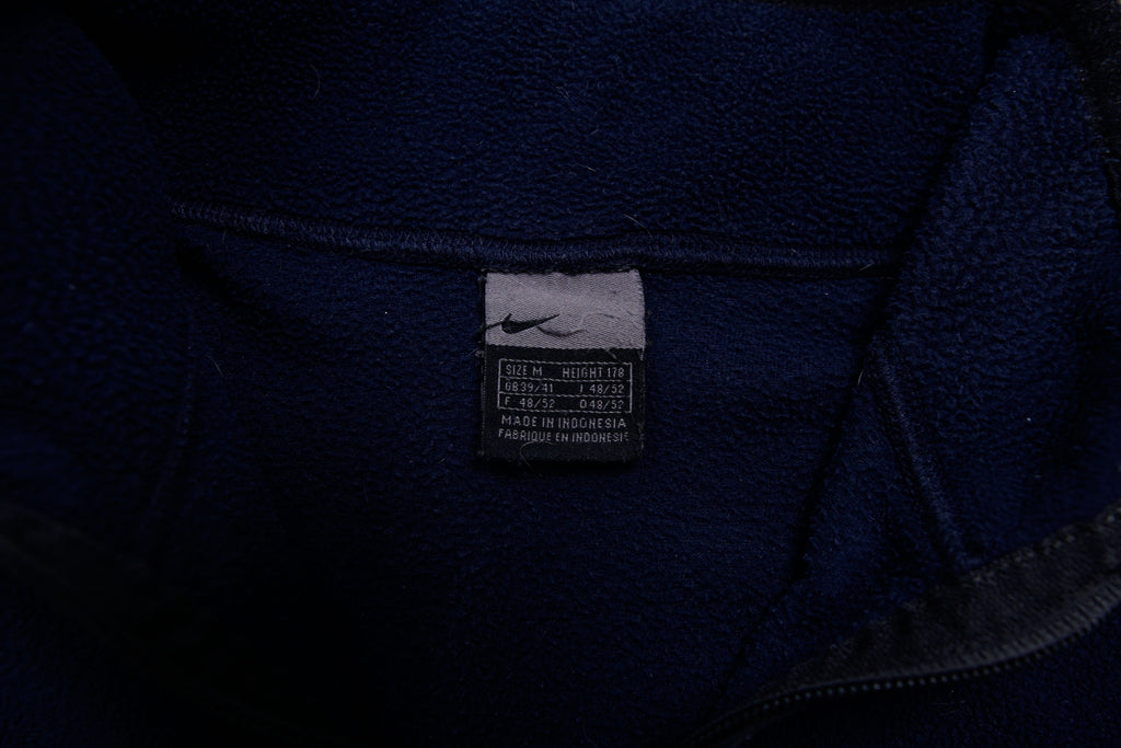 Nike fleece sweater in navy with a half-zip collar and white embroidered Swoosh, size label