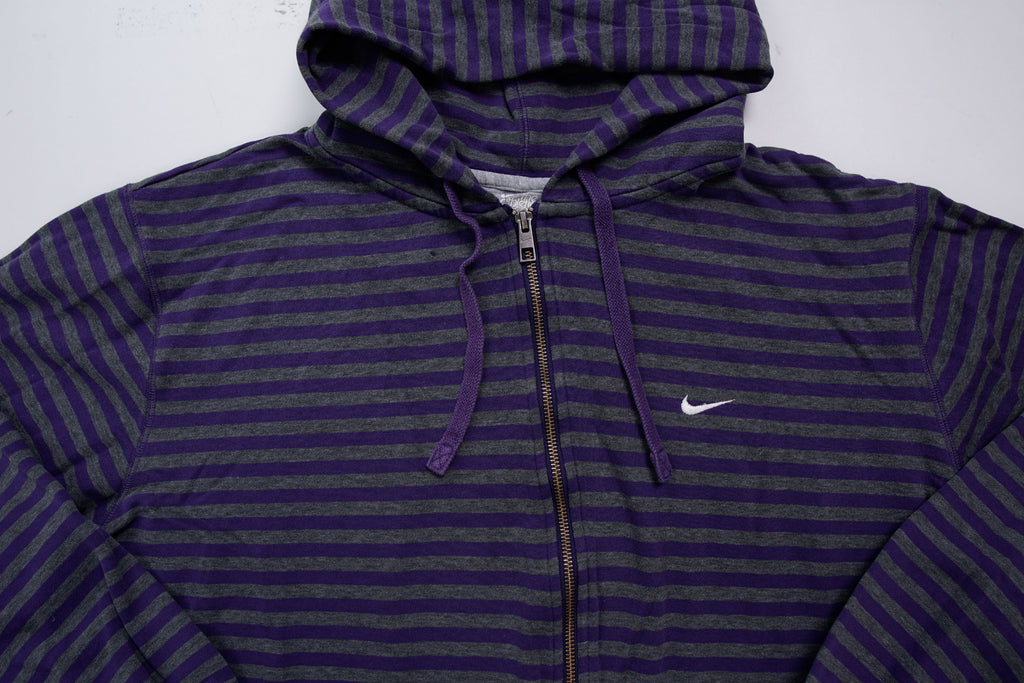 Nike zip jacket in purple and grey stripes featuring an embroidered white Swoosh logo, full view