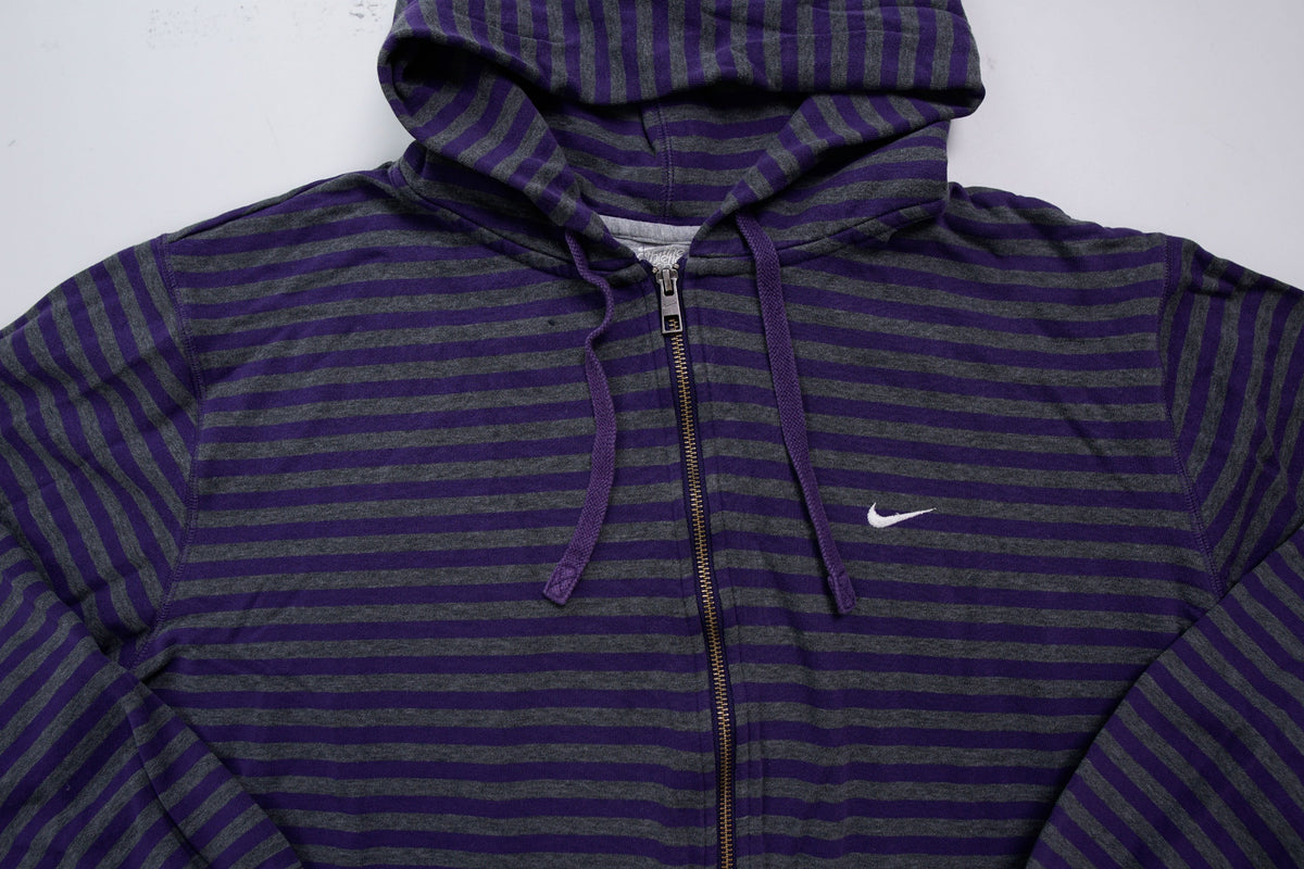 Nike zip jacket in purple and grey stripes featuring an embroidered white Swoosh logo, full view