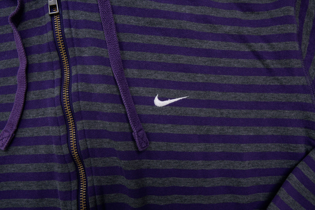 Nike zip jacket in purple and grey stripes featuring an embroidered white Swoosh logo, detail