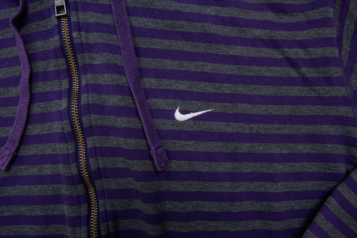 Nike zip jacket in purple and grey stripes featuring an embroidered white Swoosh logo, detail