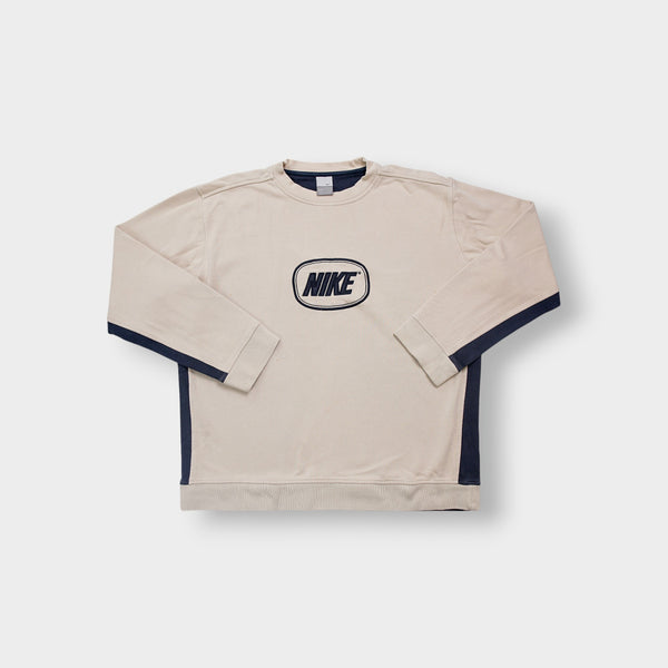 Nike sweater in beige and navy featuring an embroidered oval logo on the chest