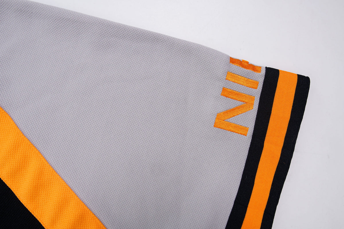 Nike short-sleeve jacket in black and grey with orange stripes and collar detail, detail