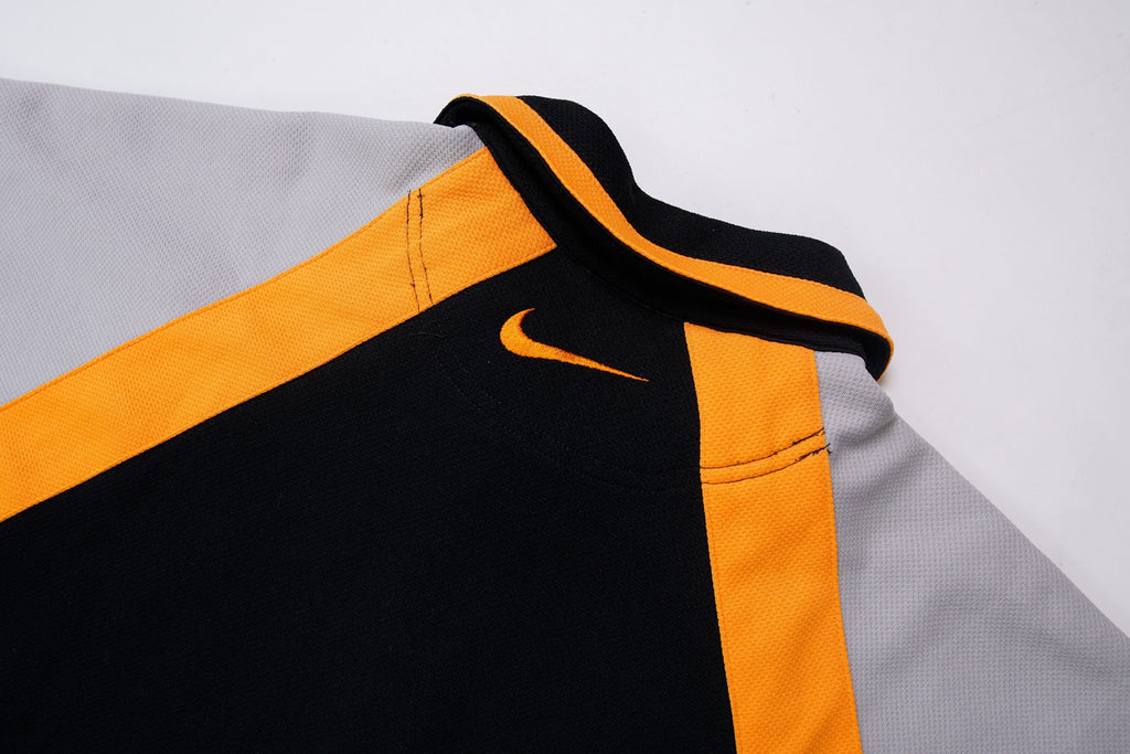 Nike short-sleeve jacket in black and grey with orange stripes and collar detail, back view