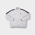 Nike track jacket in white and navy featuring an embroidered RF logo on the chest
