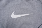 Nike crewneck sweater in grey with a large white embroidered swoosh applique on the chest, detail
