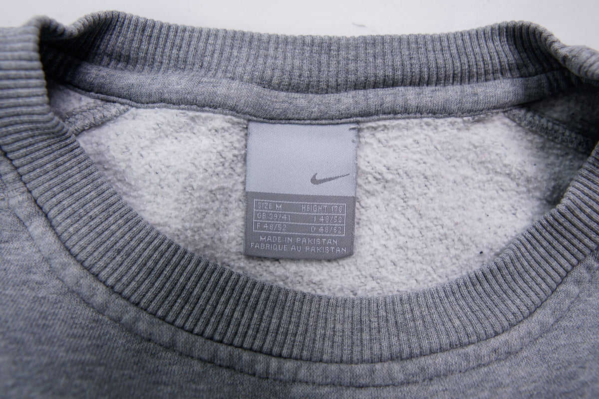 Nike crewneck sweater in grey with a large white embroidered swoosh applique on the chest, size label