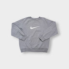 Nike crewneck sweater in grey with a large white embroidered swoosh applique on the chest