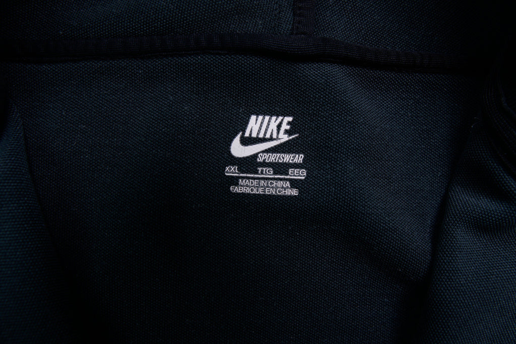 Nike track jacket in black featuring an embroidered swoosh logo on the chest, size label